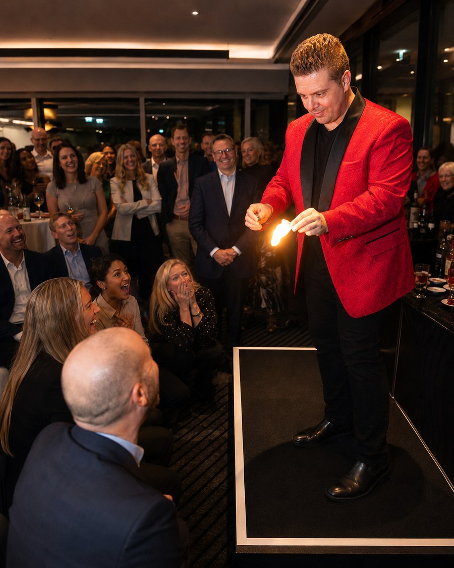 John Messina performing a stand-up stage magic show at a Sydney corporate event