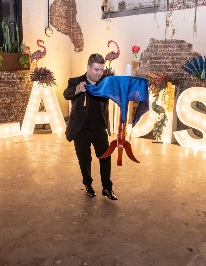 John Messina performing a stage magic show at a large corporate event in Sydney