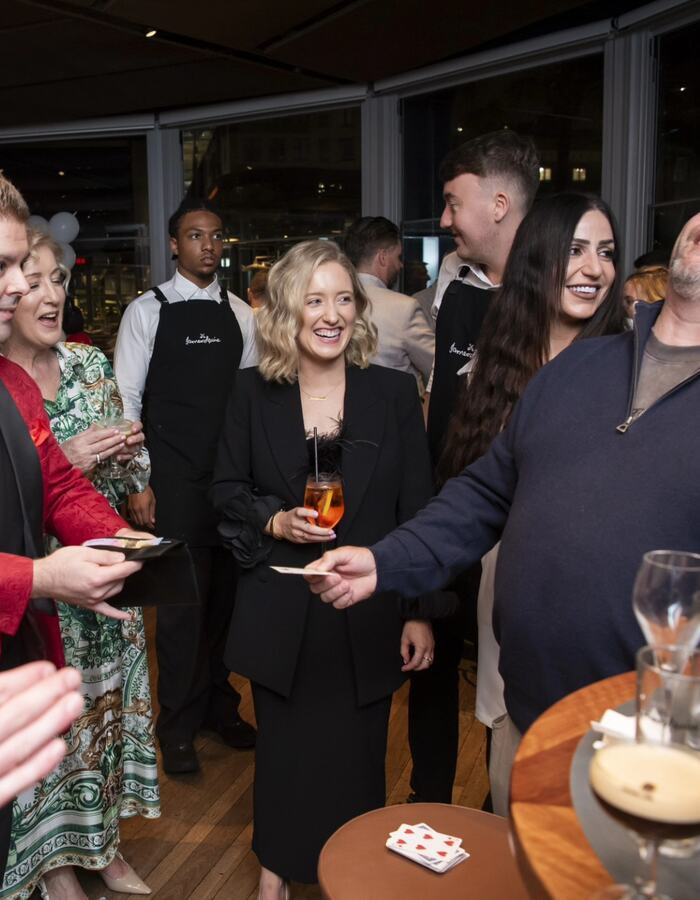 Guests at a Sydney private party laughing and reacting to John Messina's magic