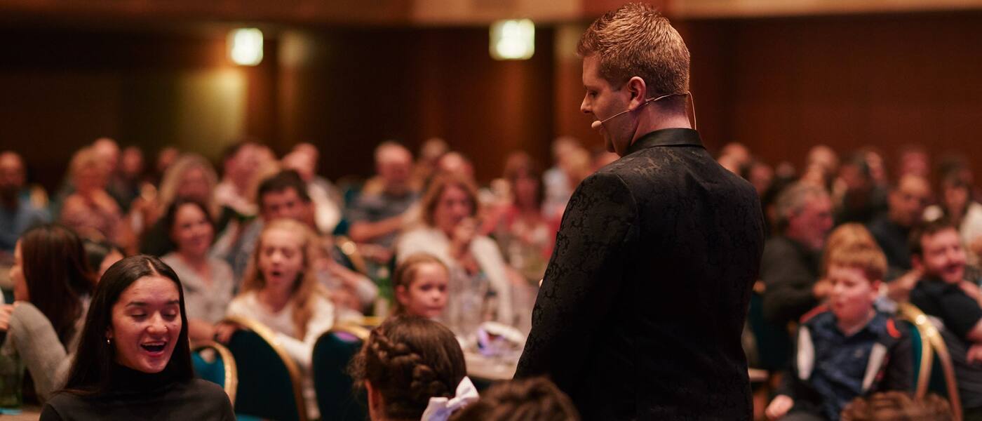 John Messina performing close-up card magic for guests at a Sydney event